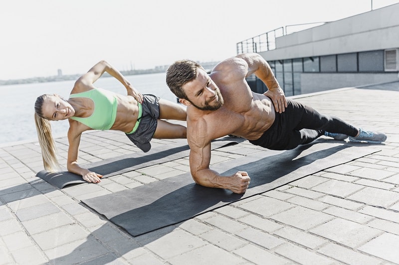 fit couple stretching before workout