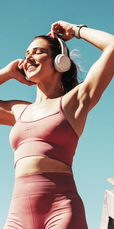 Happy healthy woman listening to music